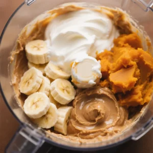 combine the Greek yogurt, mashed banana, peanut butter, and pumpkin puree.