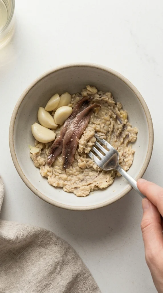 crushing garlic and anchovies together